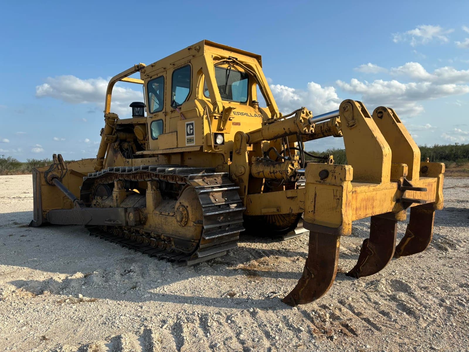 Cat D9H dozer with ripper attachment on cleared South Texas land