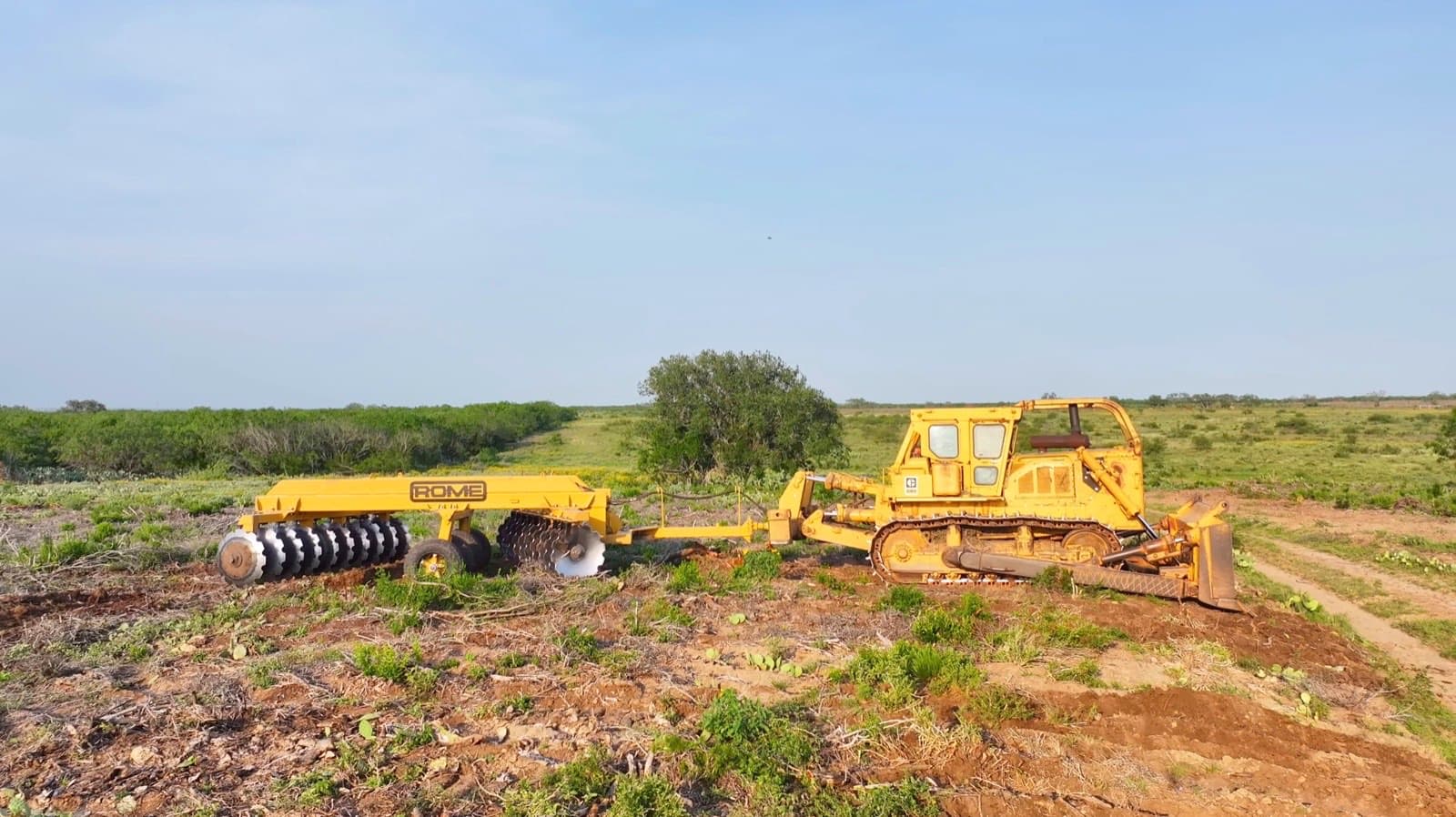 TRCW 20 Rome Plow with 42-inch blades pulled by Cat D9 dozer on cleared South Texas land